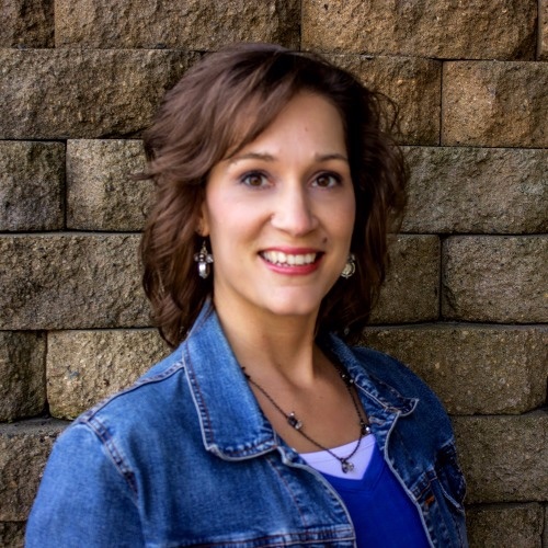 Author Paula Miller standing outside in blue shirt