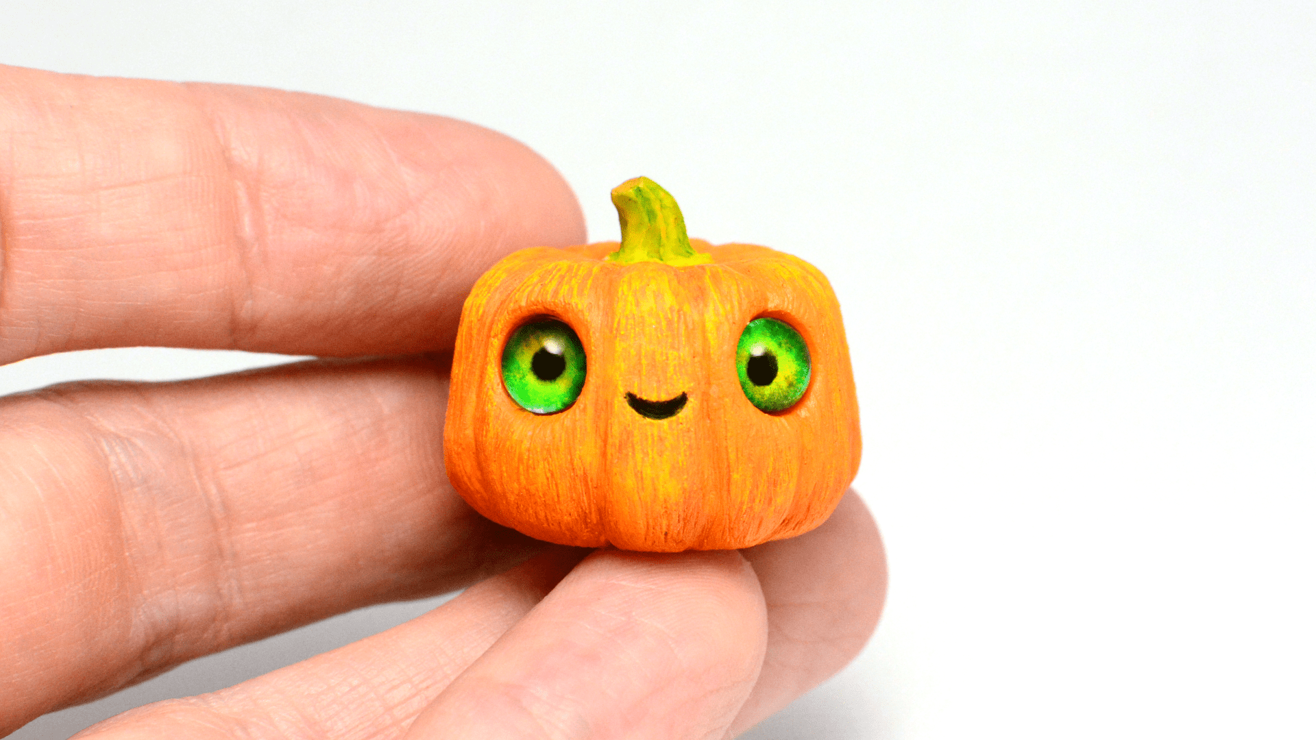 Cute mini pumpkin with green eyes