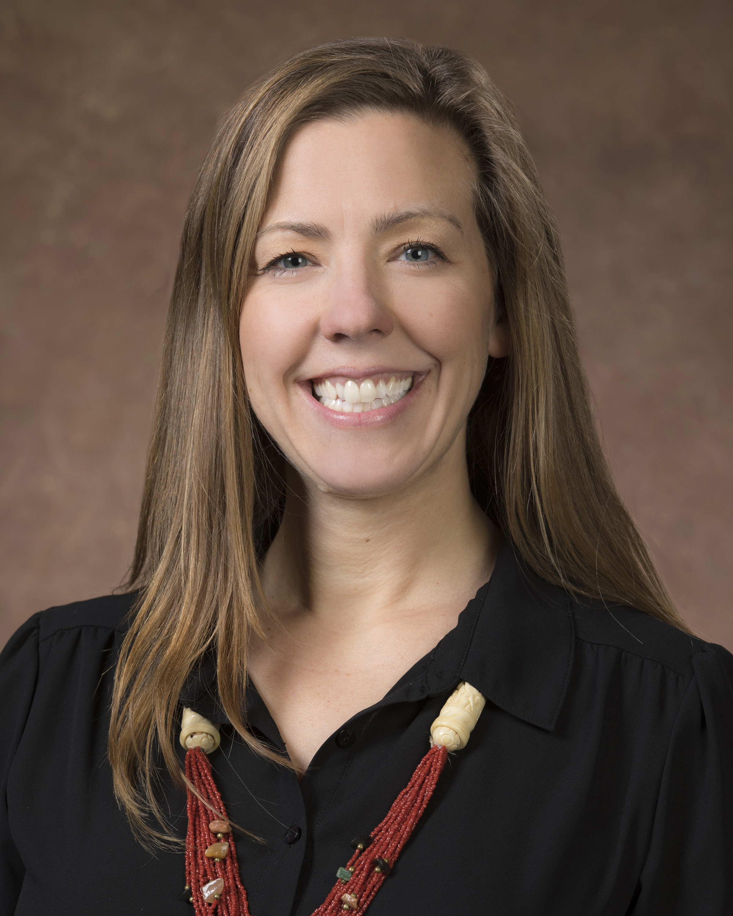 A professional headshot of Dr. Sara Coffey.