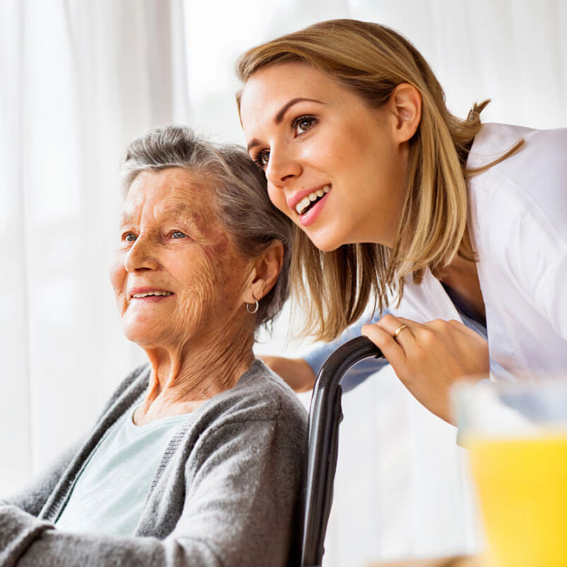 Daughter helping her aging mother in a wheelchair