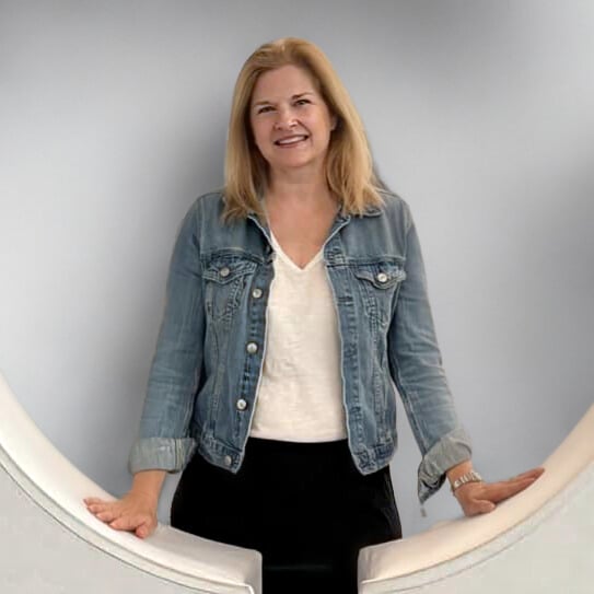 Image of Lori wearing a jean jacket, white tee shirt, and black pants