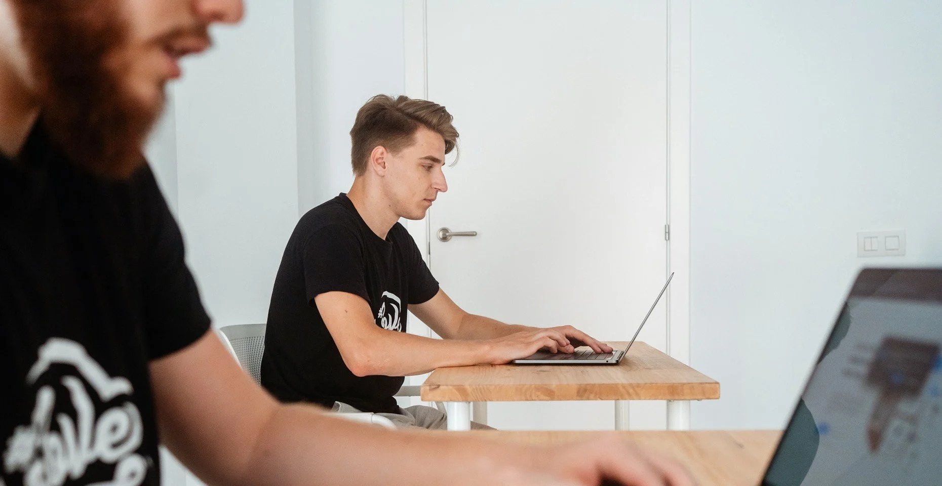 Customer support team member, Martynas, sitting with a laptop.