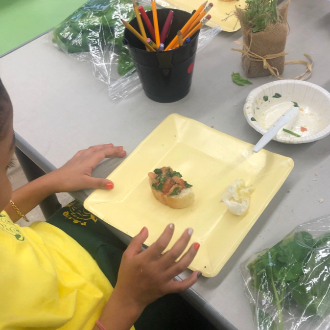 Ms. Dey's students make a snack from produce harvested in the hydroponic lab.