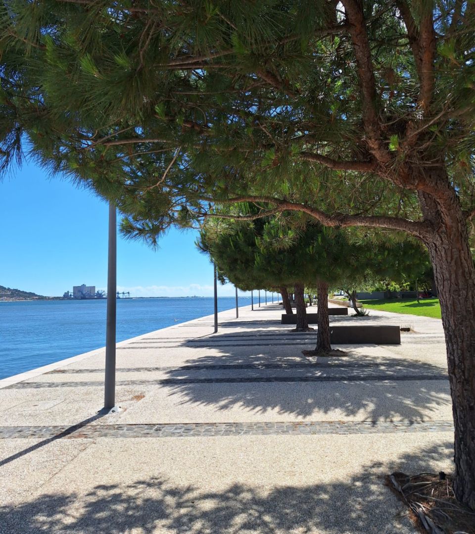 Tree-lined riverside promenade in Lisbon