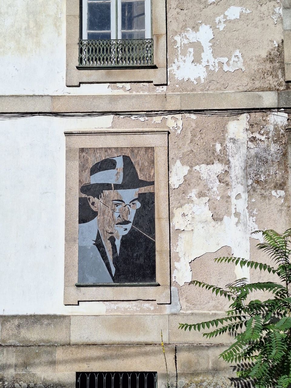 Portrait of Fernando Pessoa on an old building facade in Lisbon