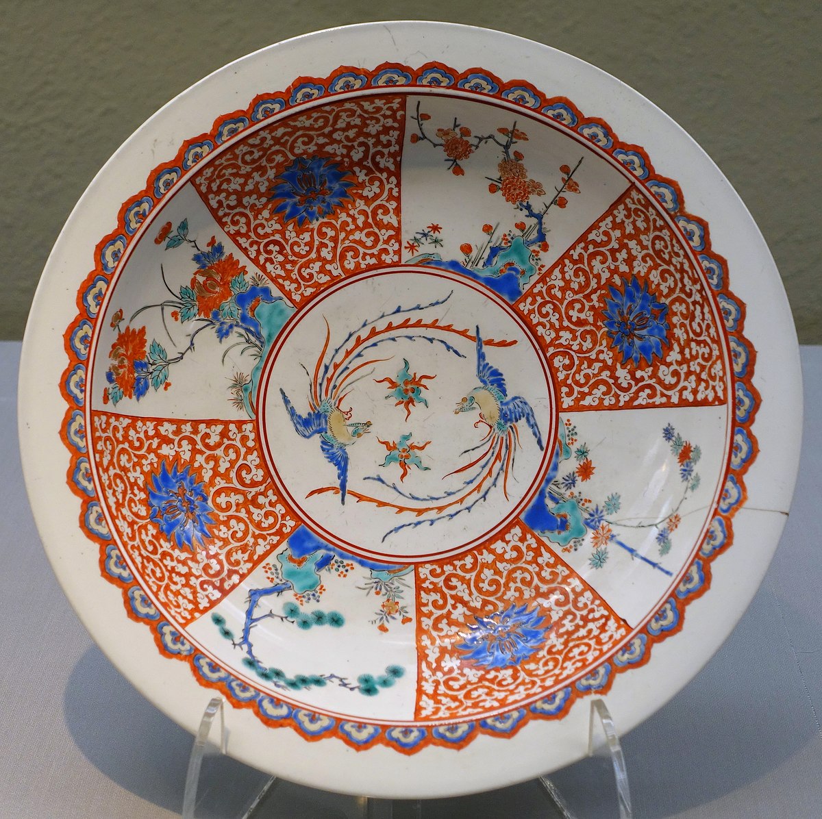 Large Imari ware dish, Kakiemon type, Edo period 17th century. Paired phoenixes with pine, bamboo and plum (the three friends of winter) and peony, in overglaze enamel. Tokyo National Museum collection.