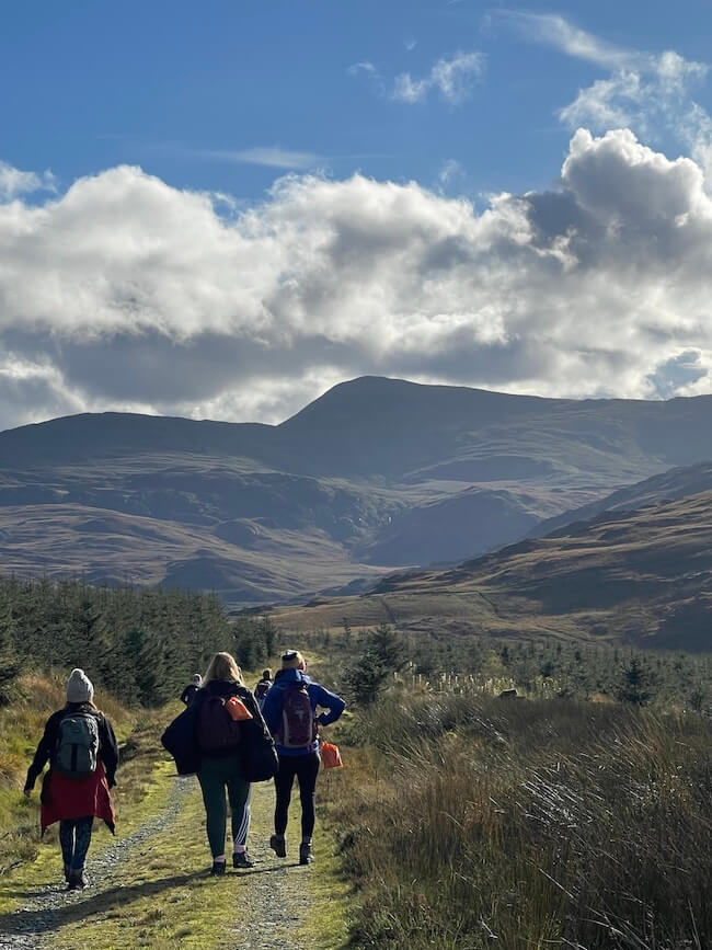 Group of walkers on a trail in sunshine near Moel Siabod