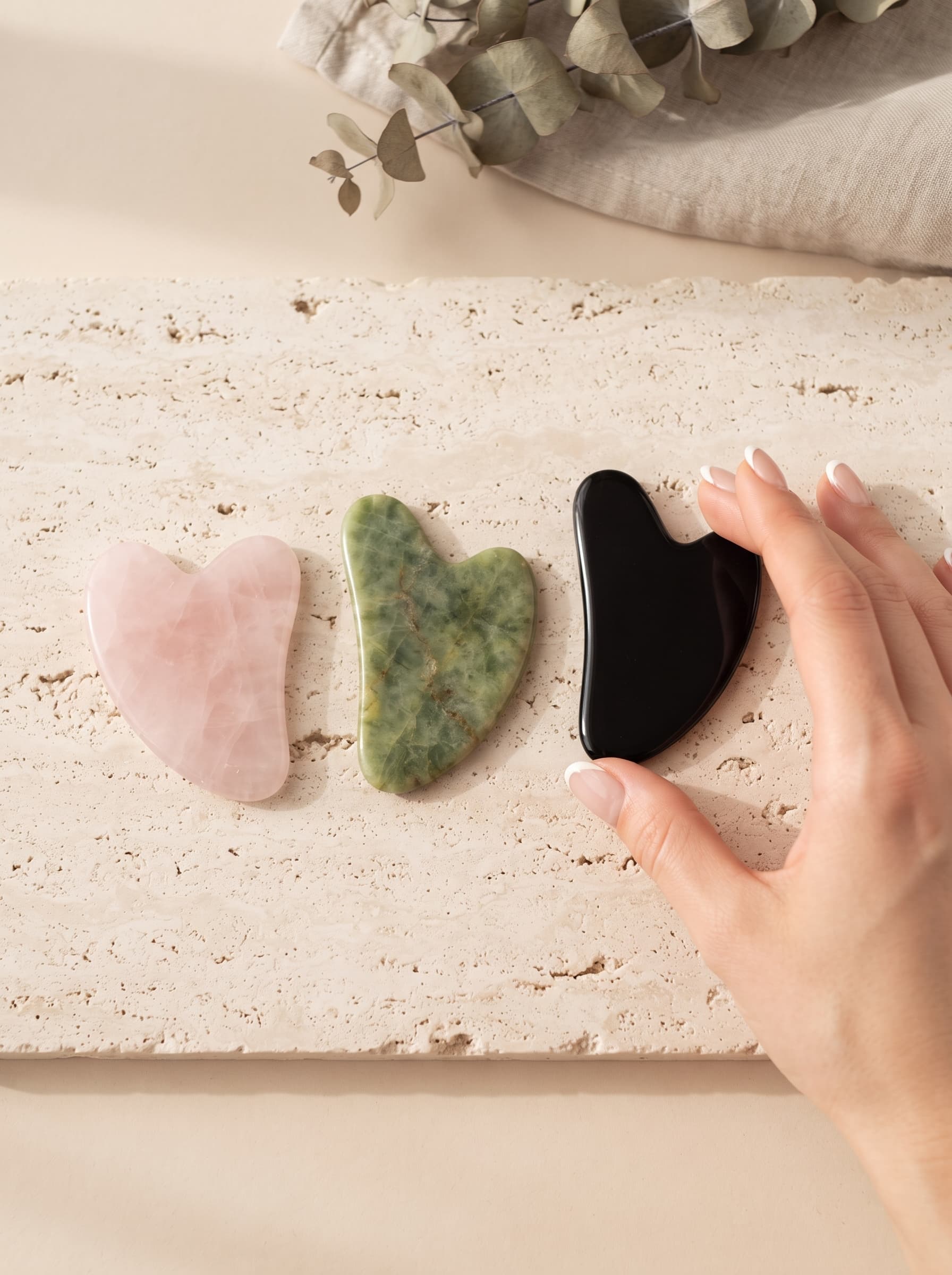 Rose quartz, jade and obsidian gua sha stones for facial massage
