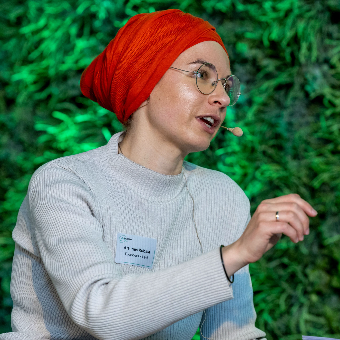 Artemis Kubala moderating a panel discussion. 