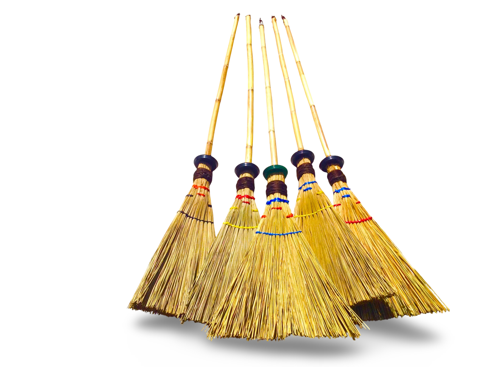 A creative shot showing a triangle broom used as wall art decoration while hanging next to a modern pendant light fixture.