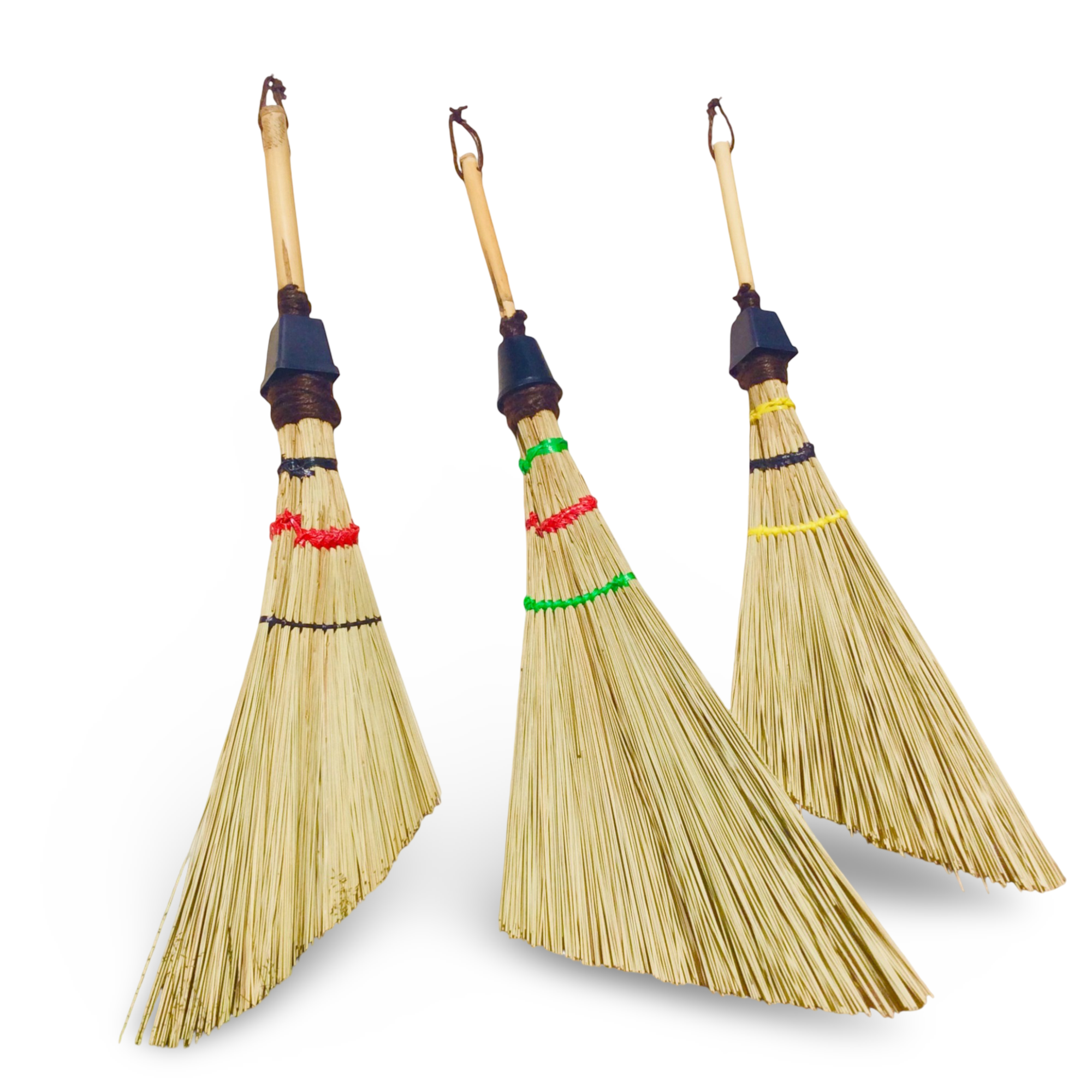 A creative shot showing a triangle broom used as wall art decoration while hanging next to a modern pendant light fixture.