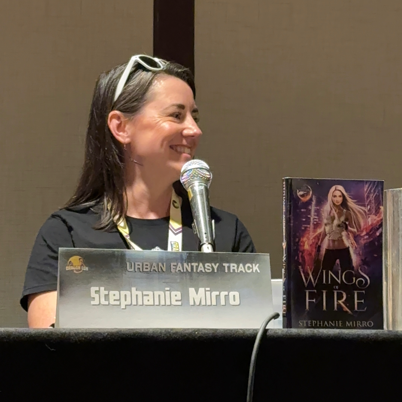 Stephanie wearing a red buffalo plaid shirt and smiling