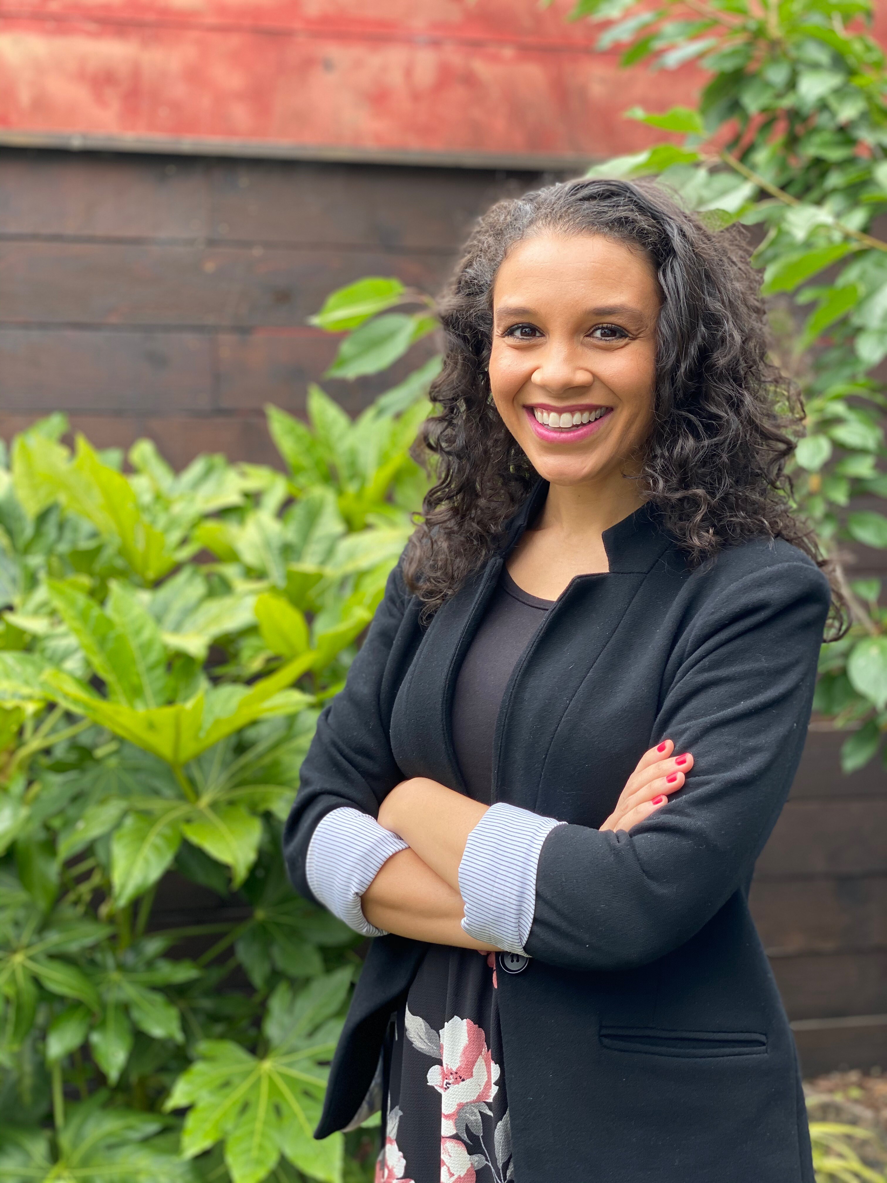 Addie woolridge is holding two pints of ice cream and a copy of her book, THe Bounce Back. She is smiling and wearing glasses.
