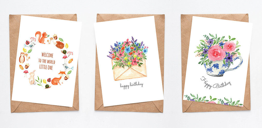 Three printable watercolour cards on brown envelopes: A baby card with a woodland animal wreath, a birthday card with watercolour wildflowers coming out of a beige envelope and a birthday card with pink flowers in a dainty blue and white teacup.