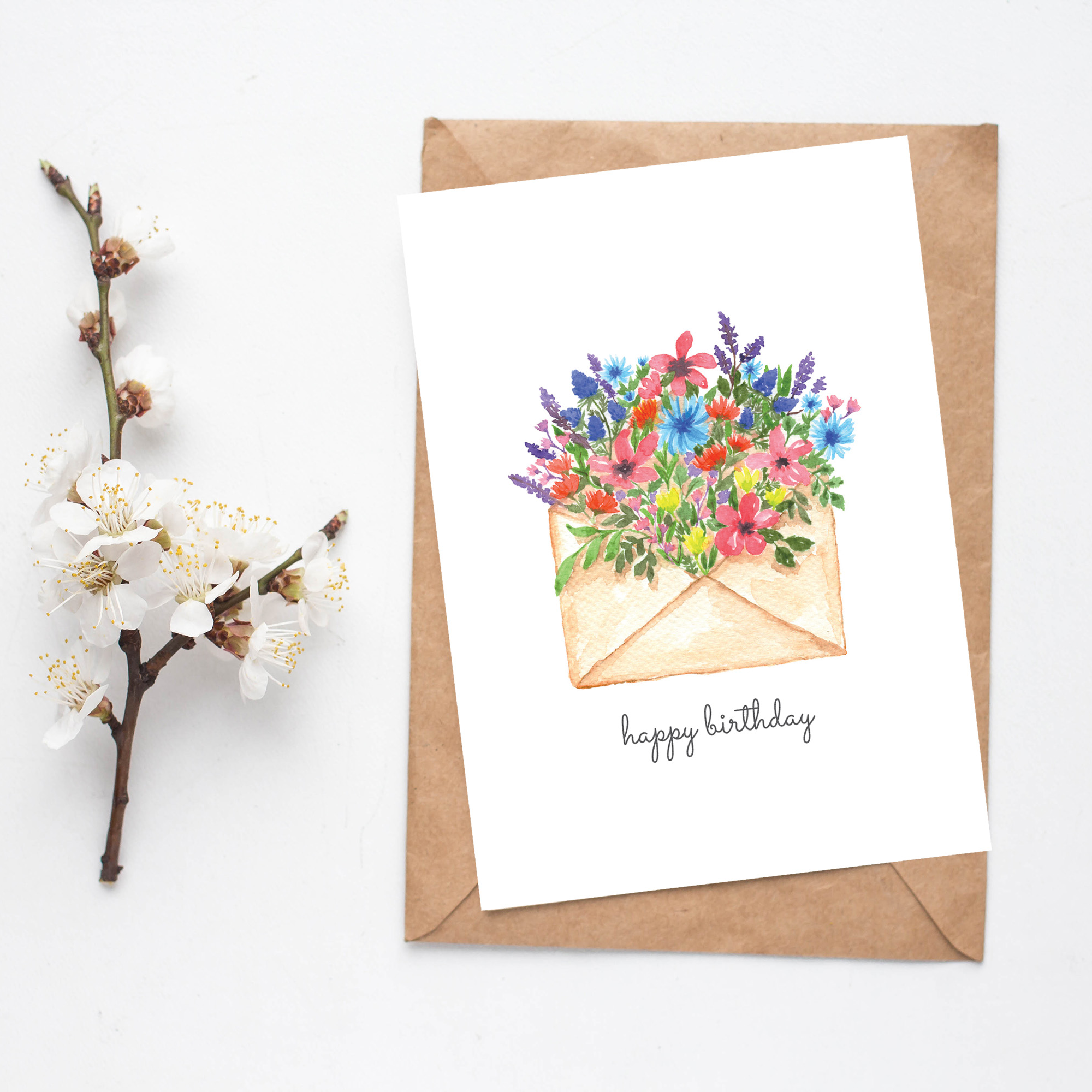 Printable birthday card with watercolour wildflowers coming out of a beige envelope