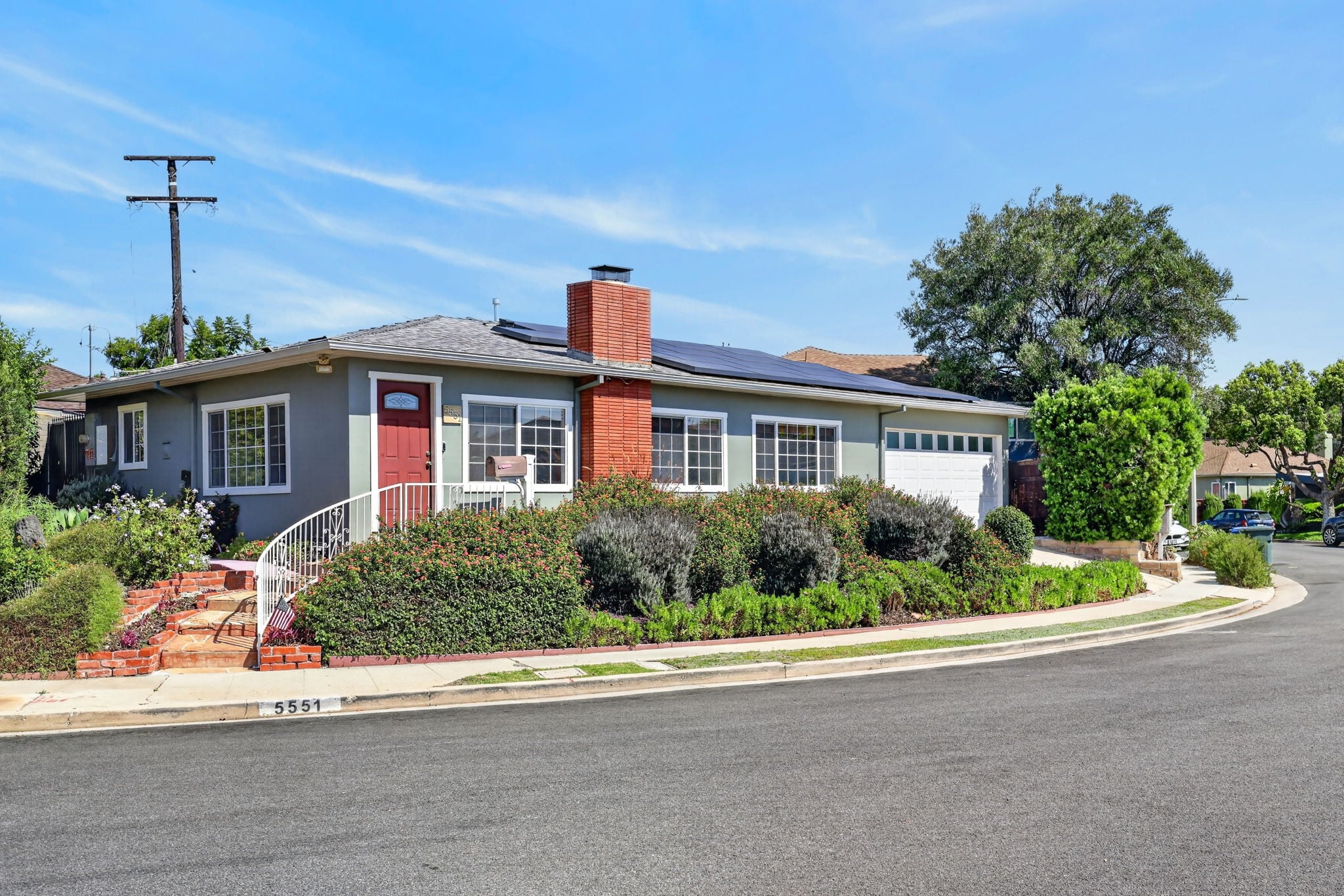 Front exterior of 5551 Arch Crest Drive on its hedged corner lot
