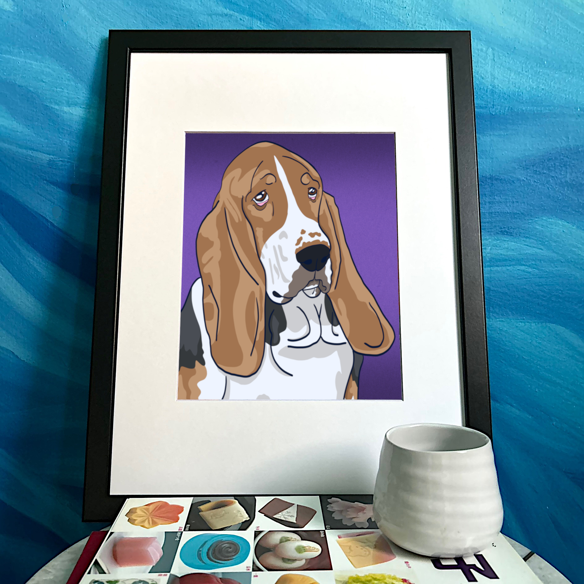 An illustrated portrait of a Basset Hound with a purple background. It’s framed and sitting on a decorated side table.