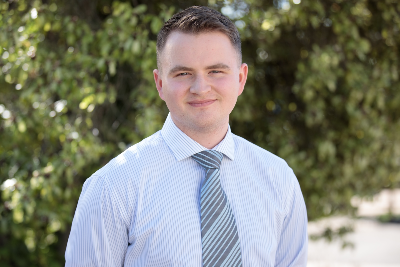 Lucan Buckley, a Daylesford Foundation scholarship recipient, smiling outdoors in front of green foliage