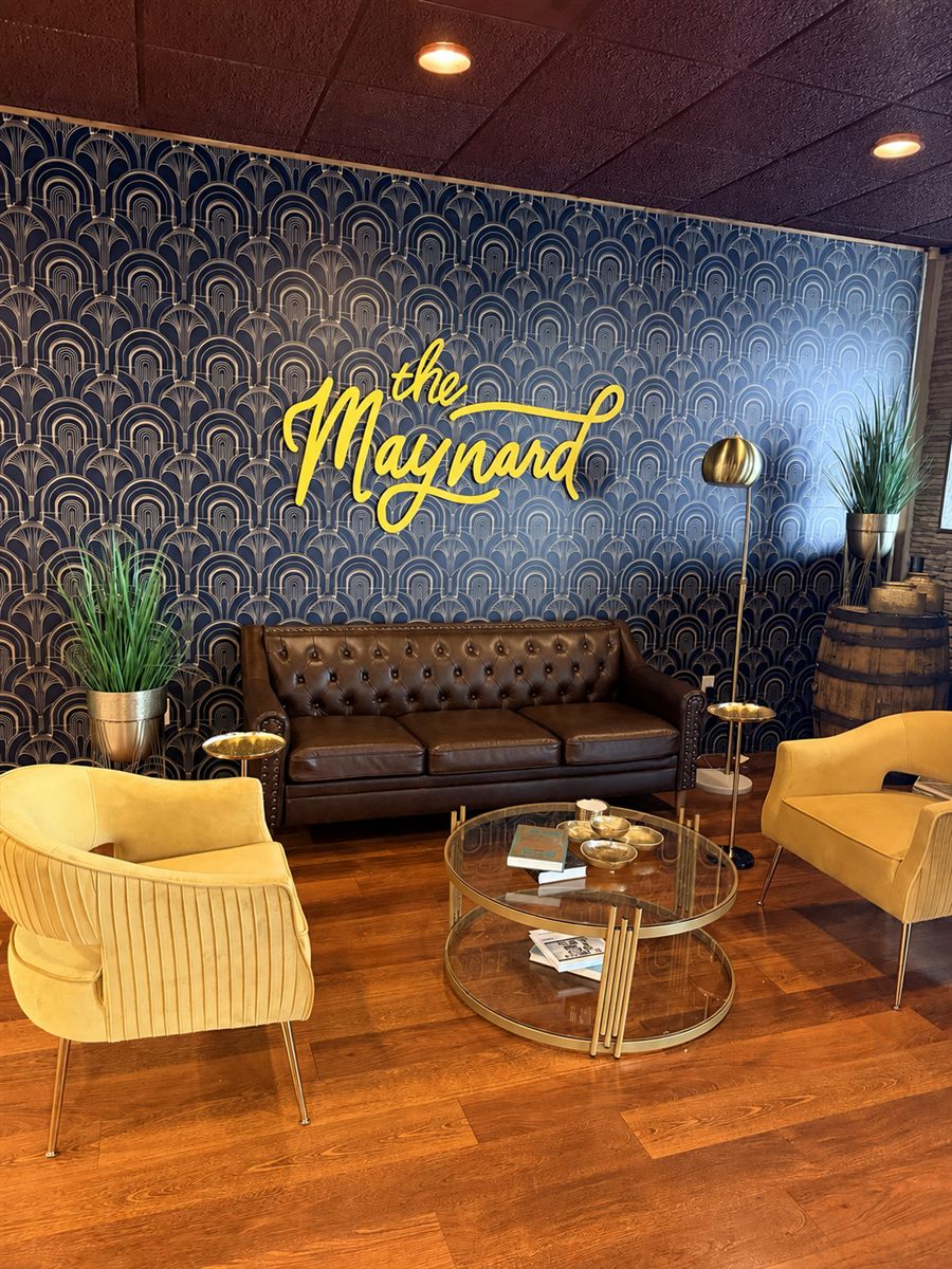 The Maynard lounge with its signature wall sign and seating area