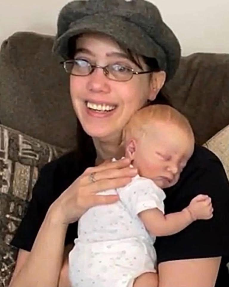 Jennifer holding one of her finished dolls