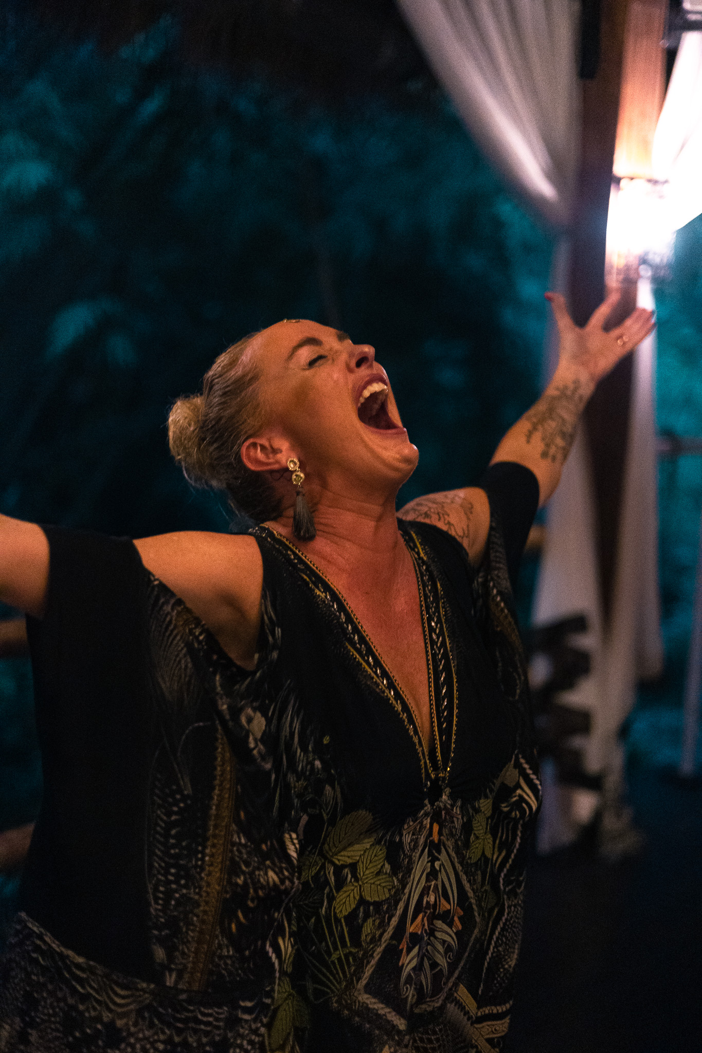 A woman with arms flung wide, voice released