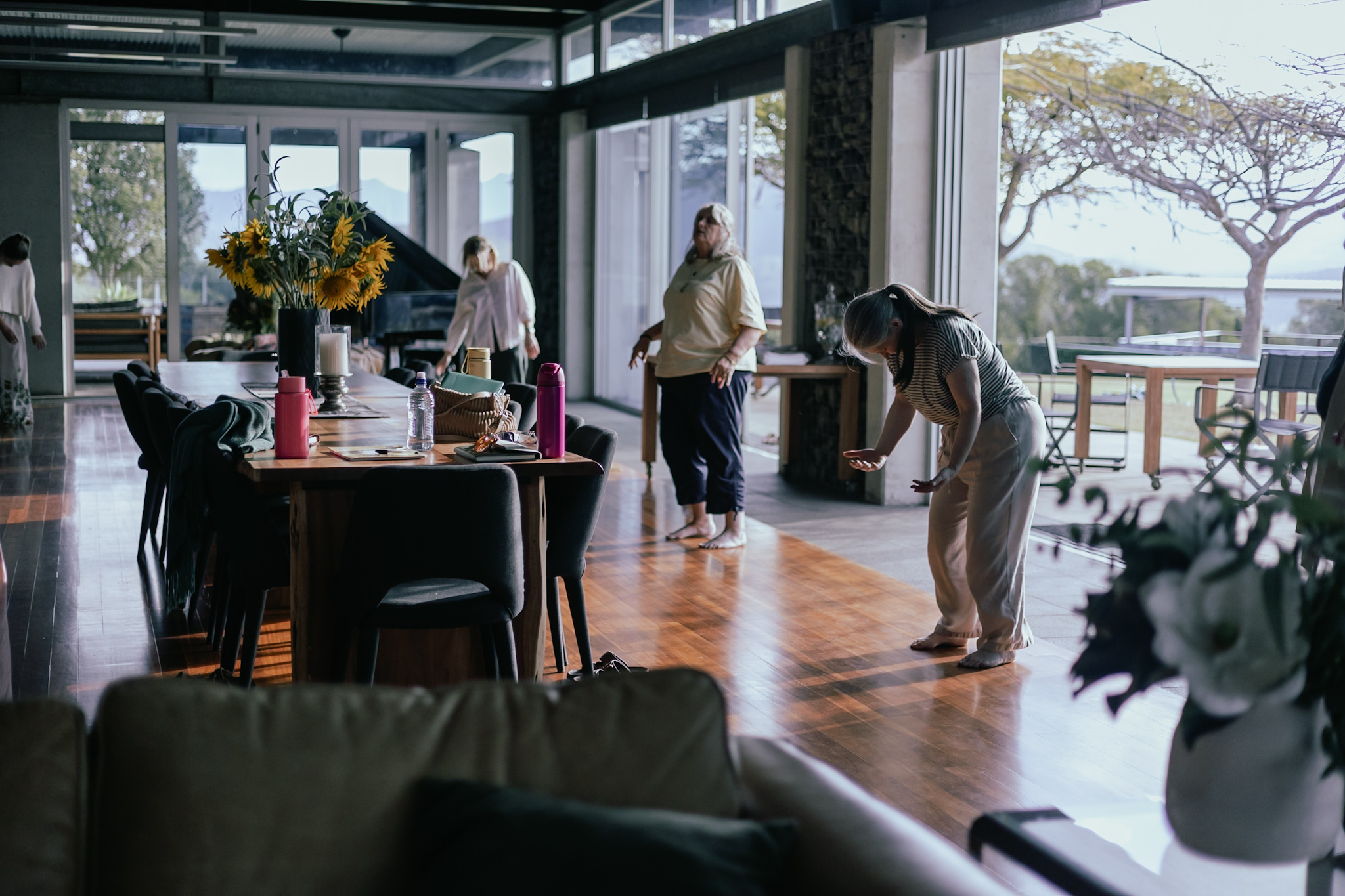 Women moving freely in a sunlit room