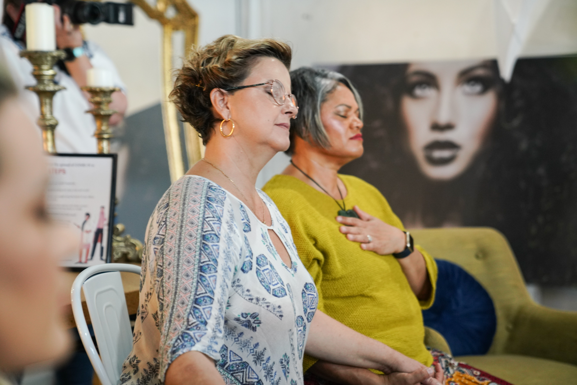 A facilitator laughing with women gathered around her