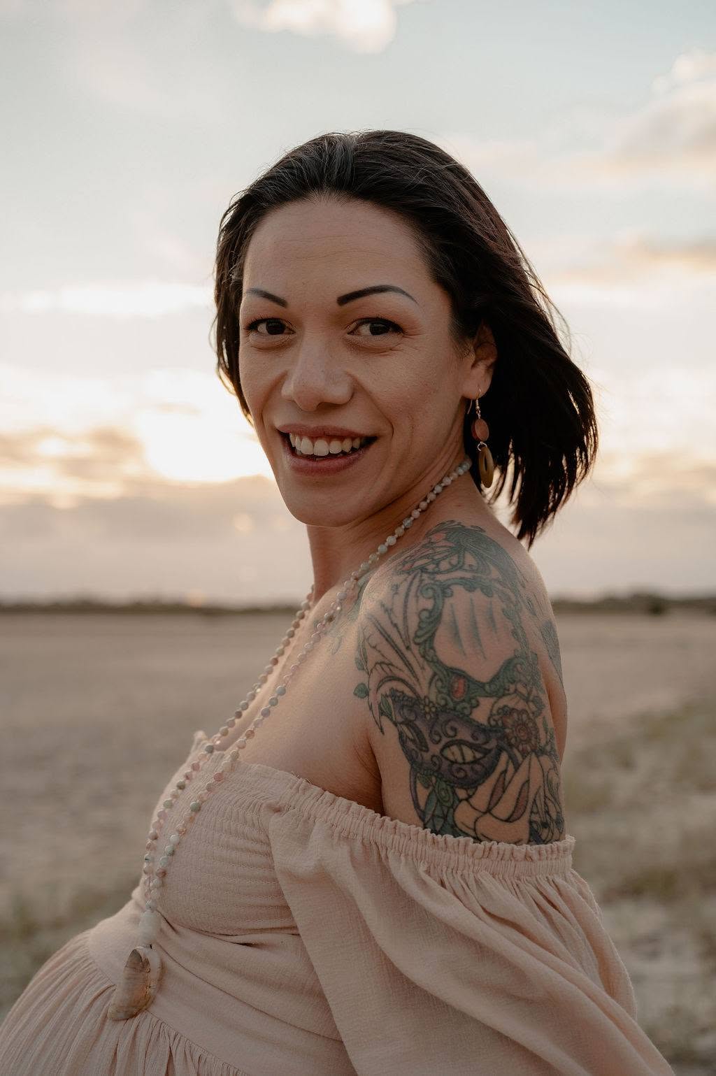 Kia West, eyes closed with her hand on her heart
