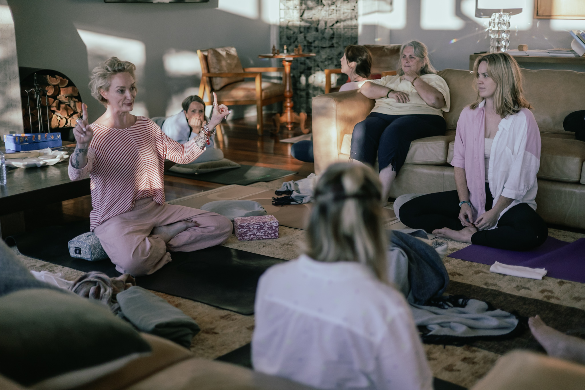 A facilitator laughing with women gathered around her