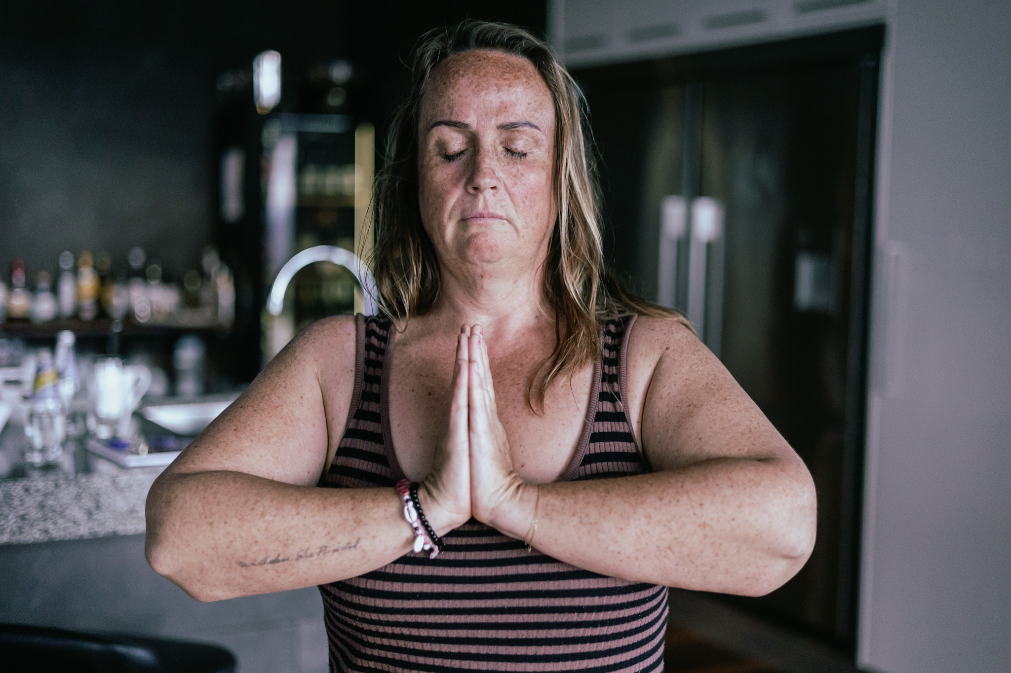 A woman with hands raised overhead