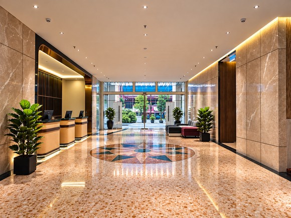 Renovated hotel lobby with reception and terrazzo floor