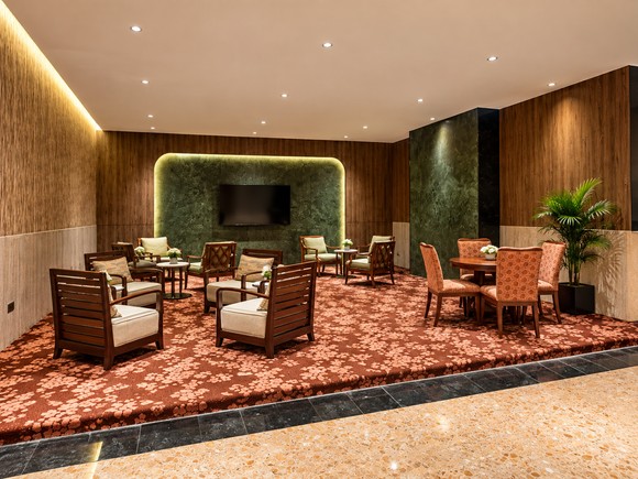 Hotel lounge with timber panelling and warm seating