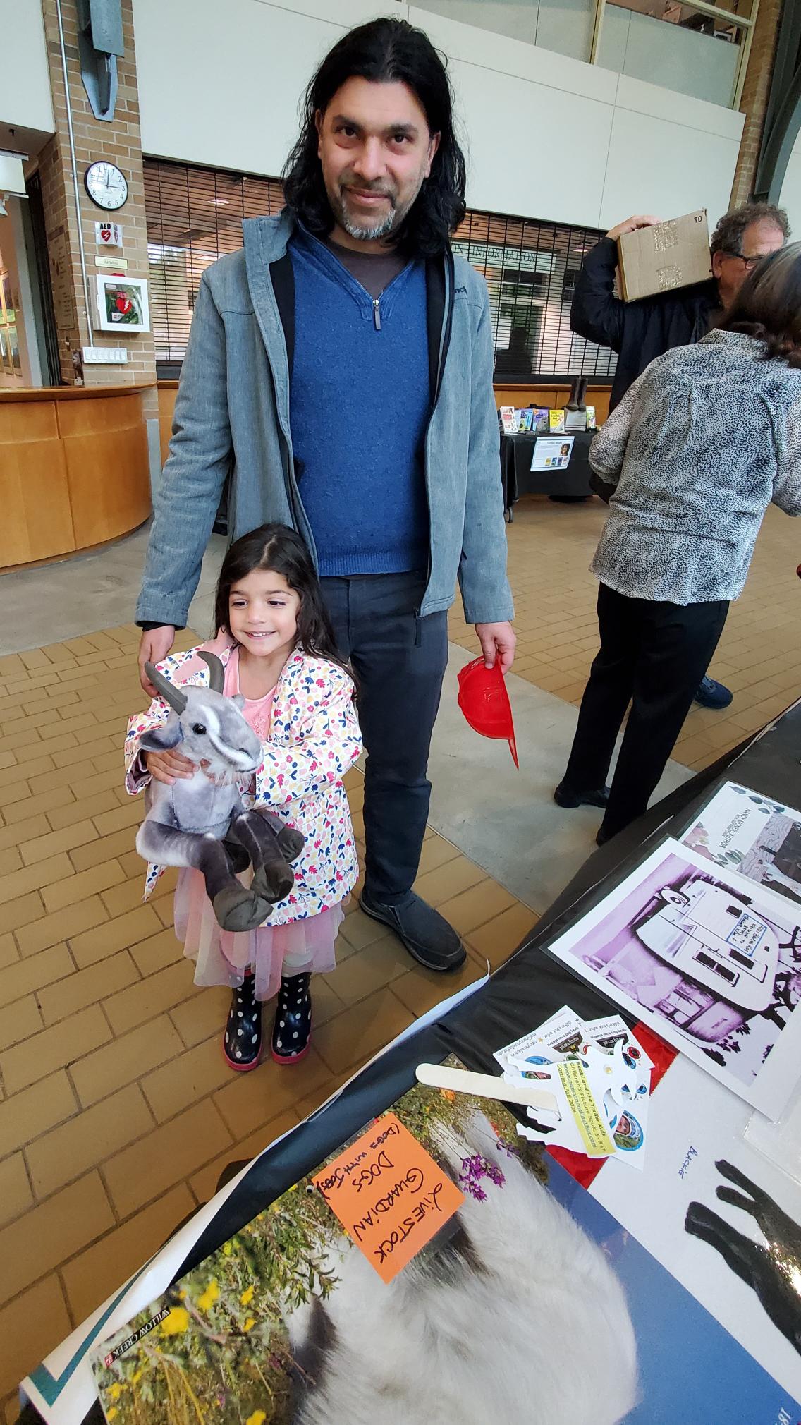 Father and daughter at a children's book author fair