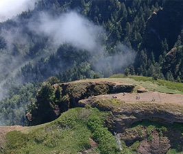 Image of a green mountainside taken with a drone-mounted camera