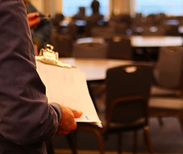 An event planner holds a clip board during an event venue site visit.