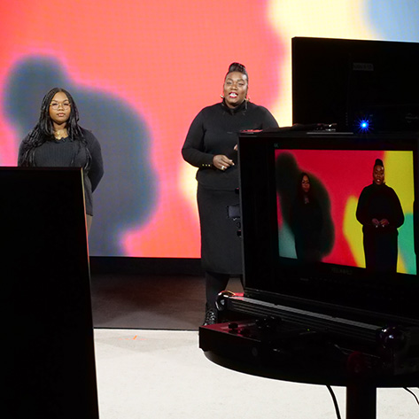 A monitor allows a cameraman to see how the two hosts will appear during a live stream.