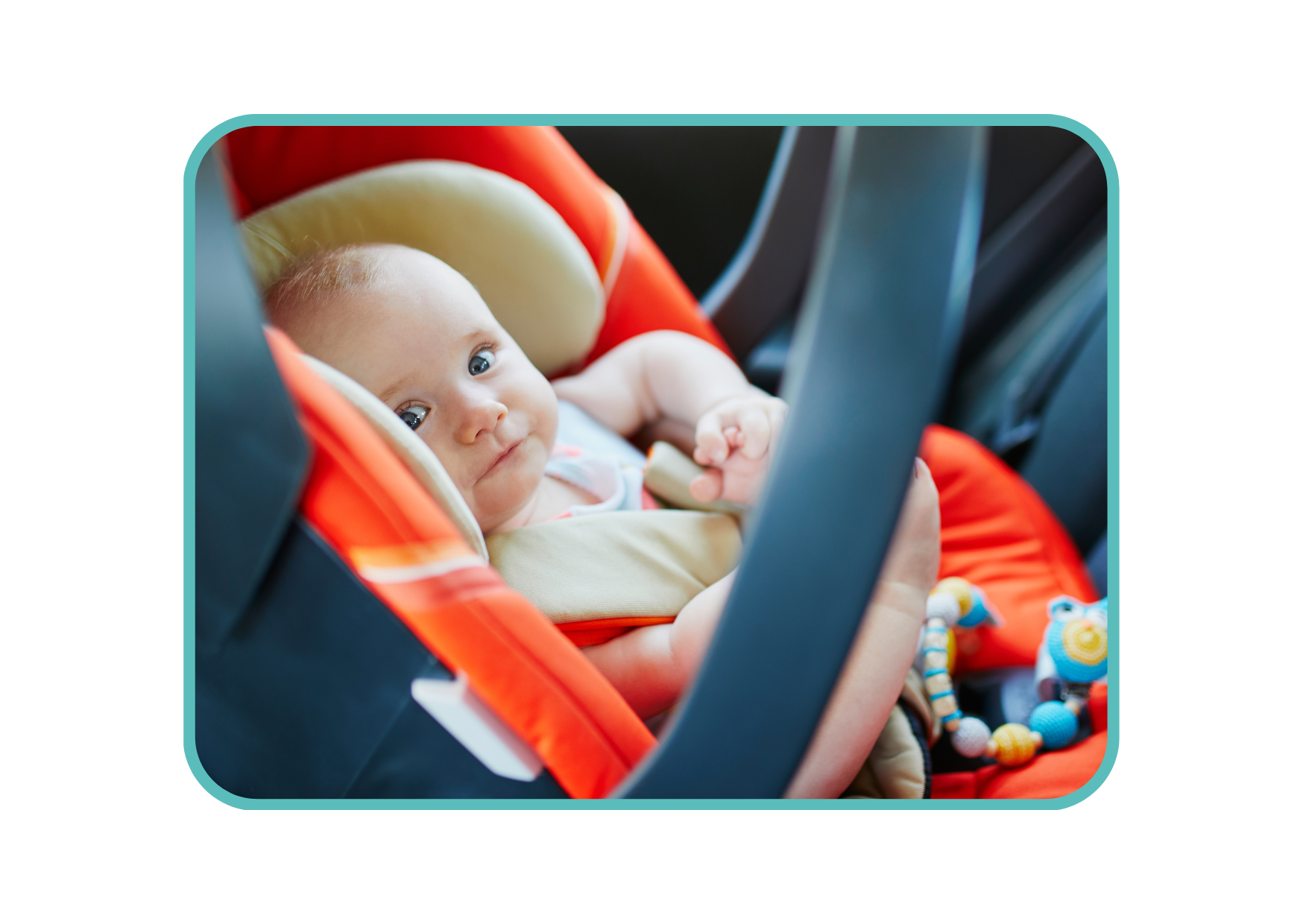 baby sitting in a baby car seat with an orange cover