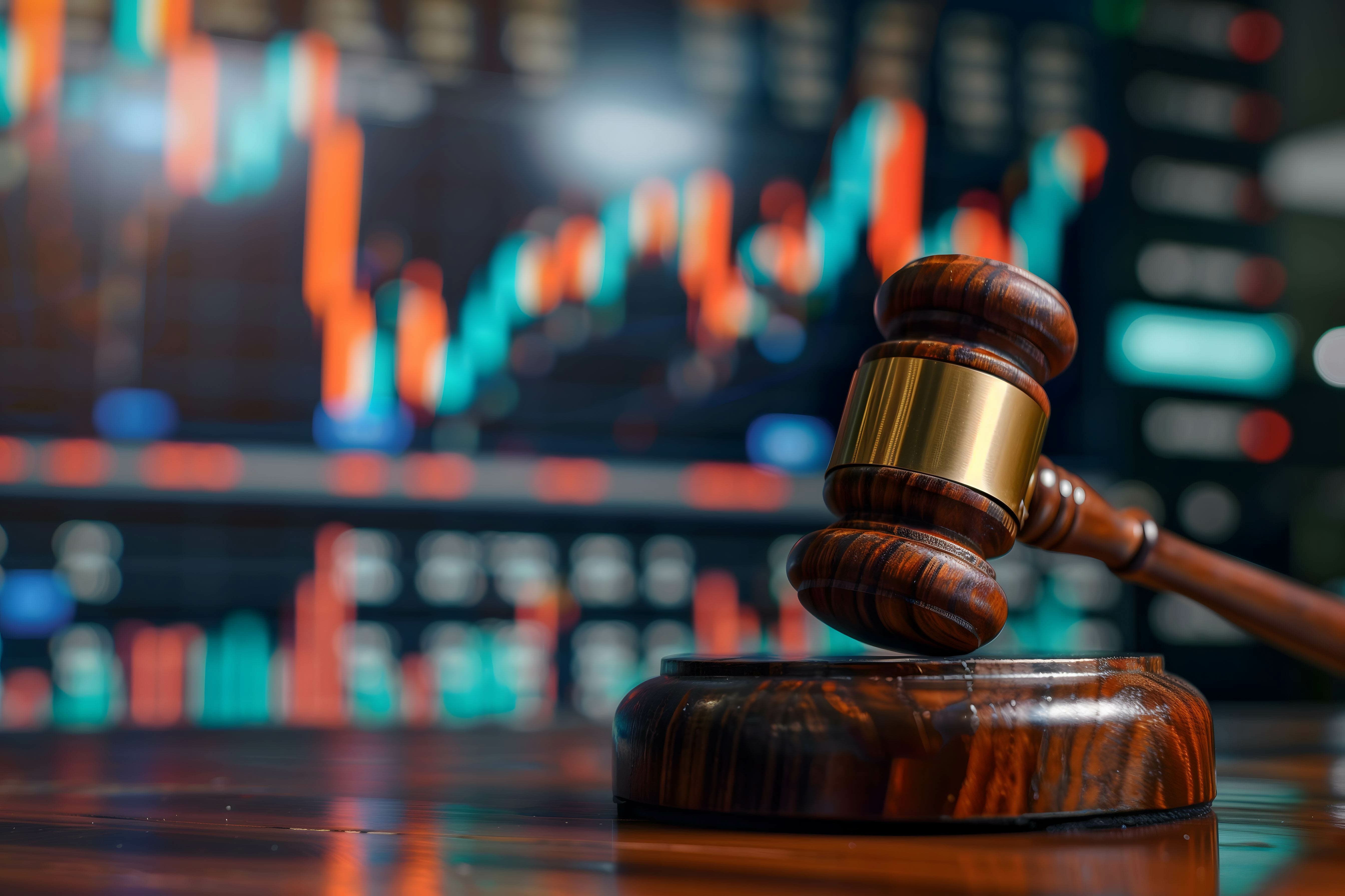 gavel with stock market background, laws and punishments for investors or executives who commit wrongdoing in investing in stock market