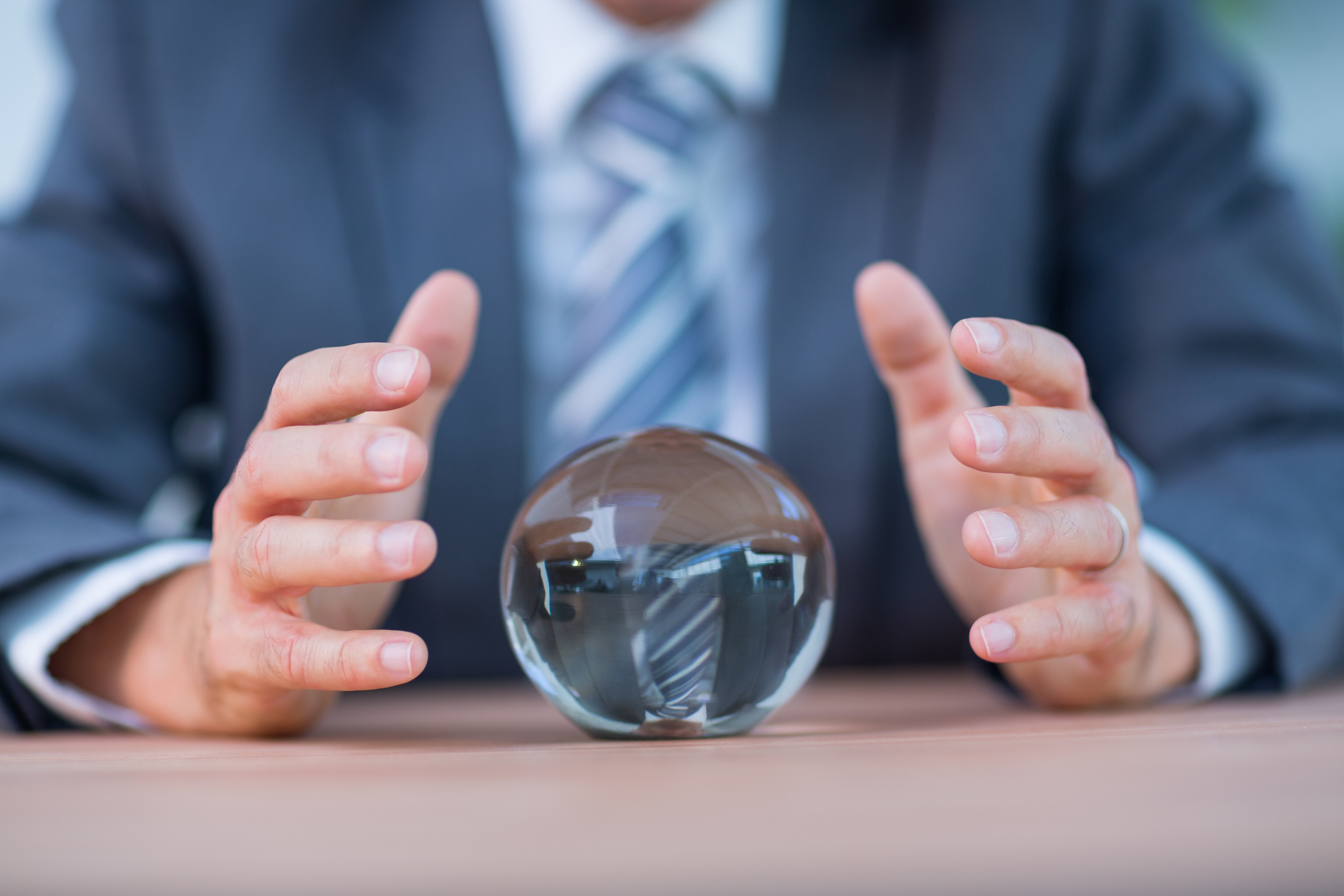 Market analyst and businessman forecasting with a crystal ball
