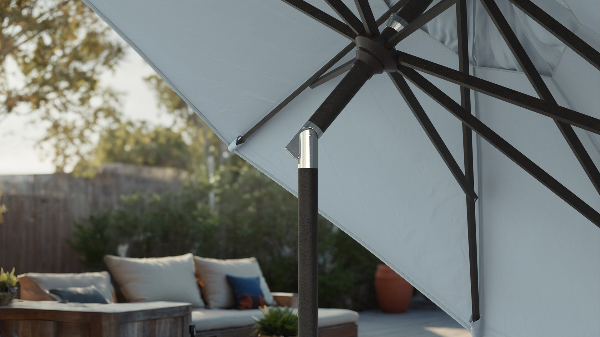 Close-up of the collar tilt  on the Golden State Series California Umbrella with Sunbrella fabric, showcasing its durable construction and smooth operation. The sleek design provides easy adjustment to block the smechanismun at any angle, perfect for creating shade during fall evenings.