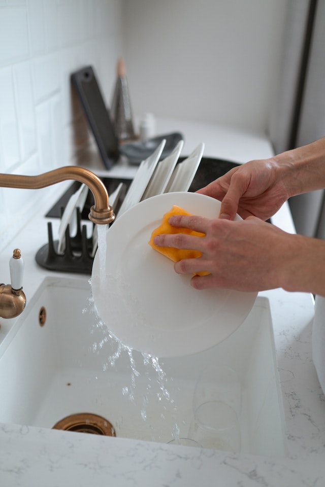 Washing Dishes in Kitchen Sink