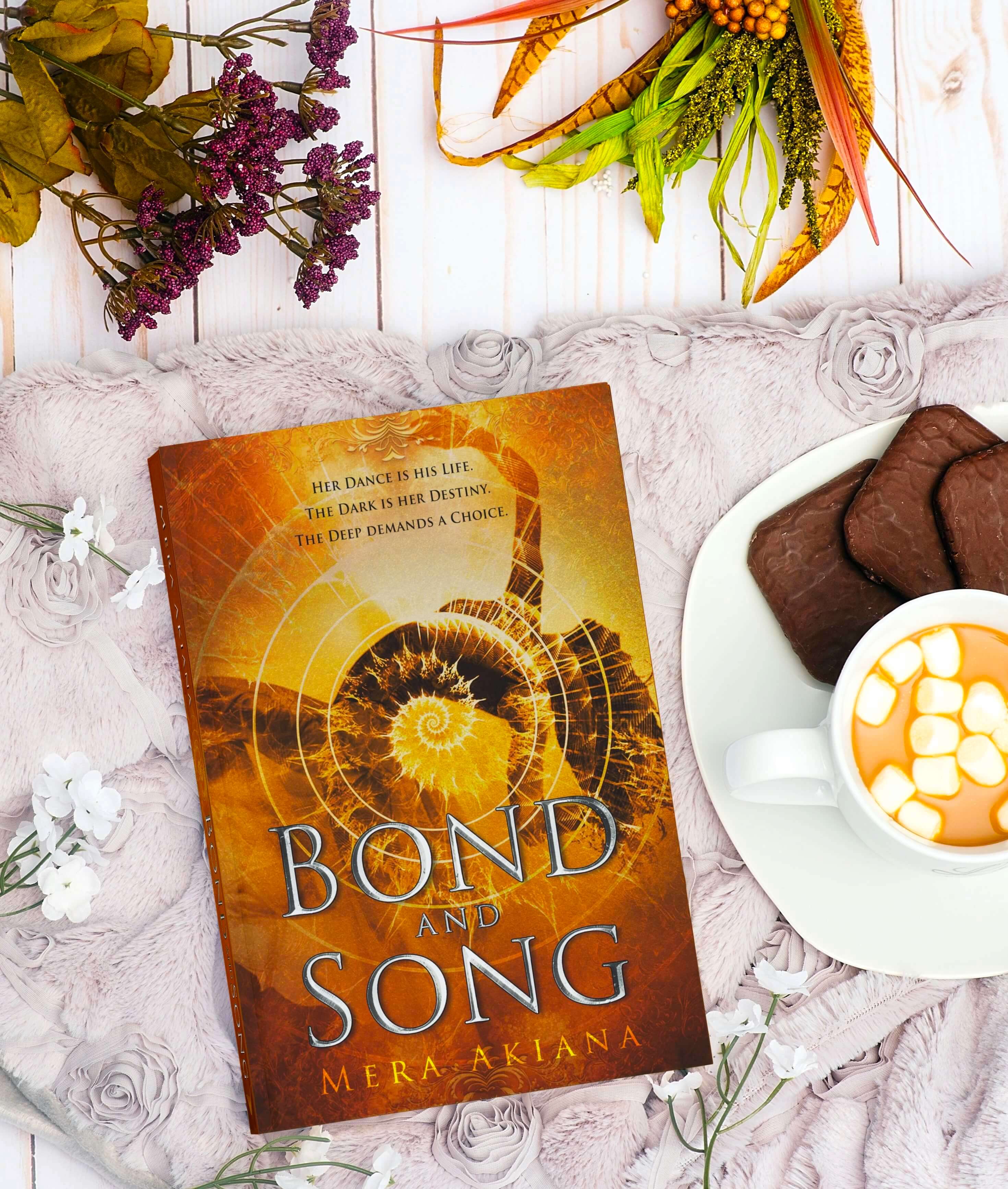 paperback of novel Bond and Song in cozy arrangement