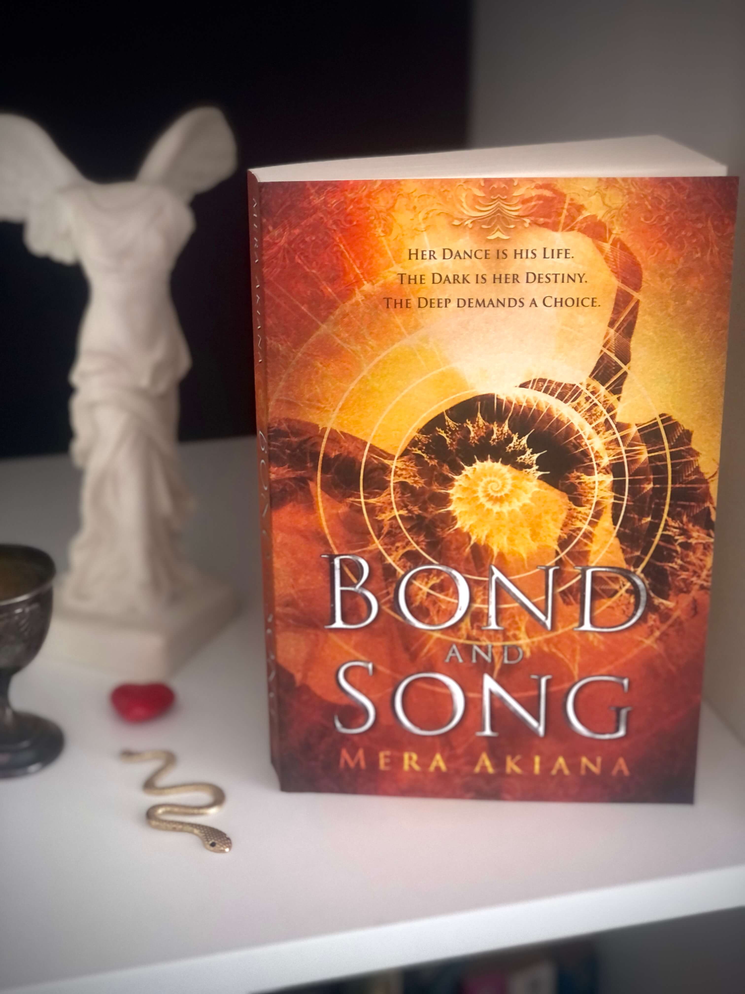 paperback of novel Bond and Song with decorative items