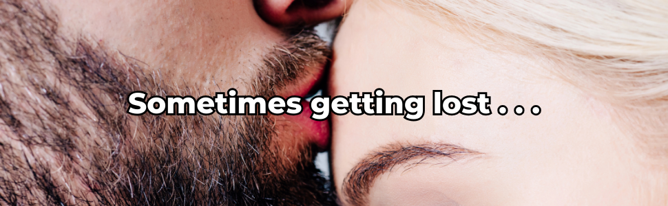 Close-up of a bearded man kissing a blonde woman’s forehead, with the words “Sometimes getting lost…” in bold white text.