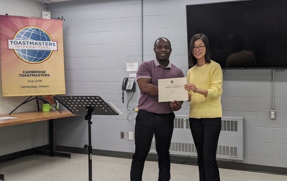 Jing Li receiving participant's certificate from Robson Masungo