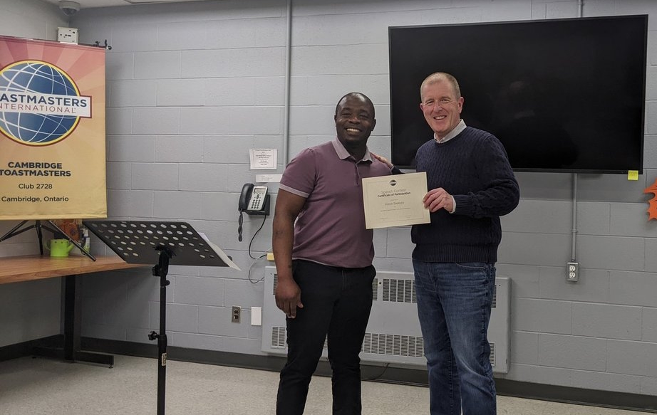 Kevin Swayze receiving participant's certificate from Robson Masungo
