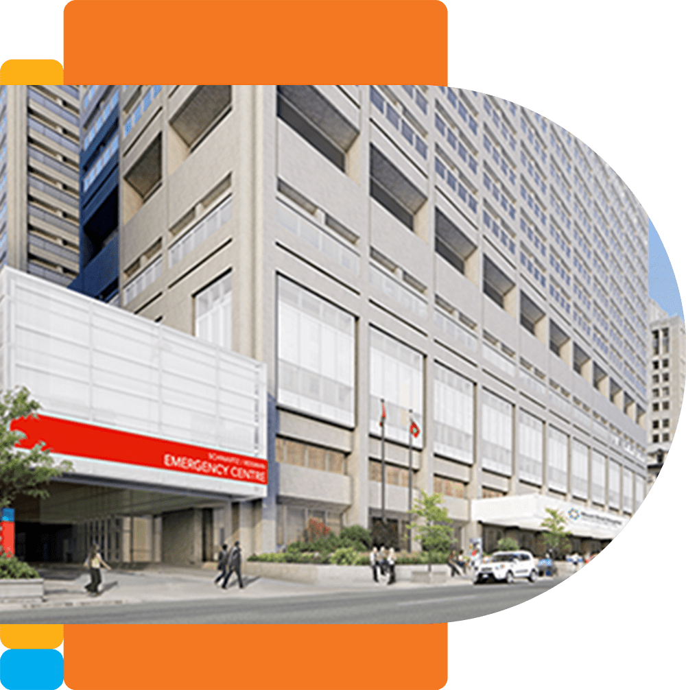 Front of Mount Sinai Hospital, with the Emergency Department entrance on the left, and the main sand coloured building on the right. A sidewalk with pedestrians is in foreground.