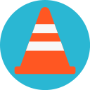 a bright orange traffic cone on a light blue and bright yellow background