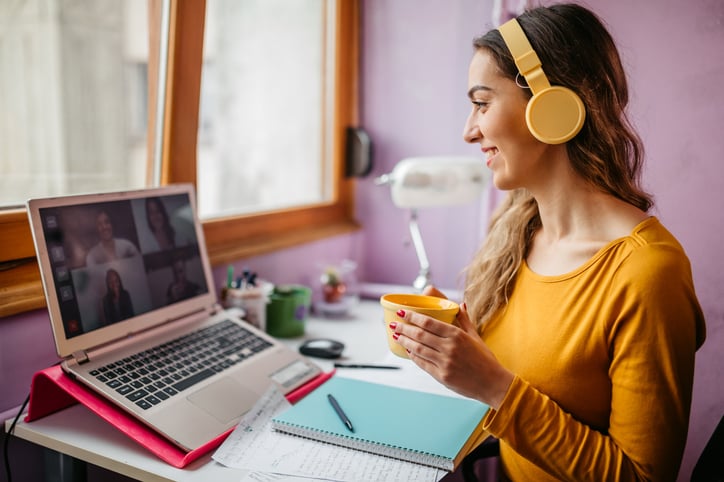 Woman studying Italian at home with colleagues via video conference