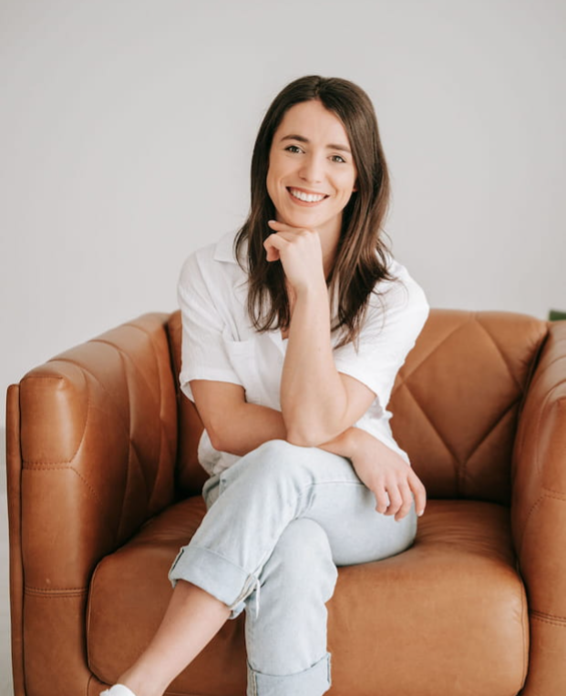 Rhiannon, Accredited Practising Dietitian specialising in coeliac disease and gut health, smiling on a couch